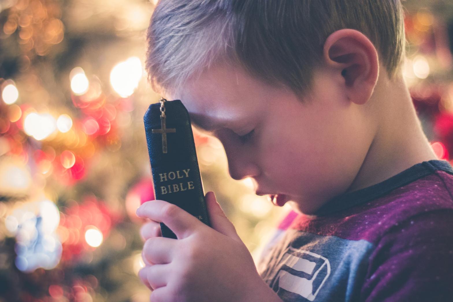 A boy holding the Bible
